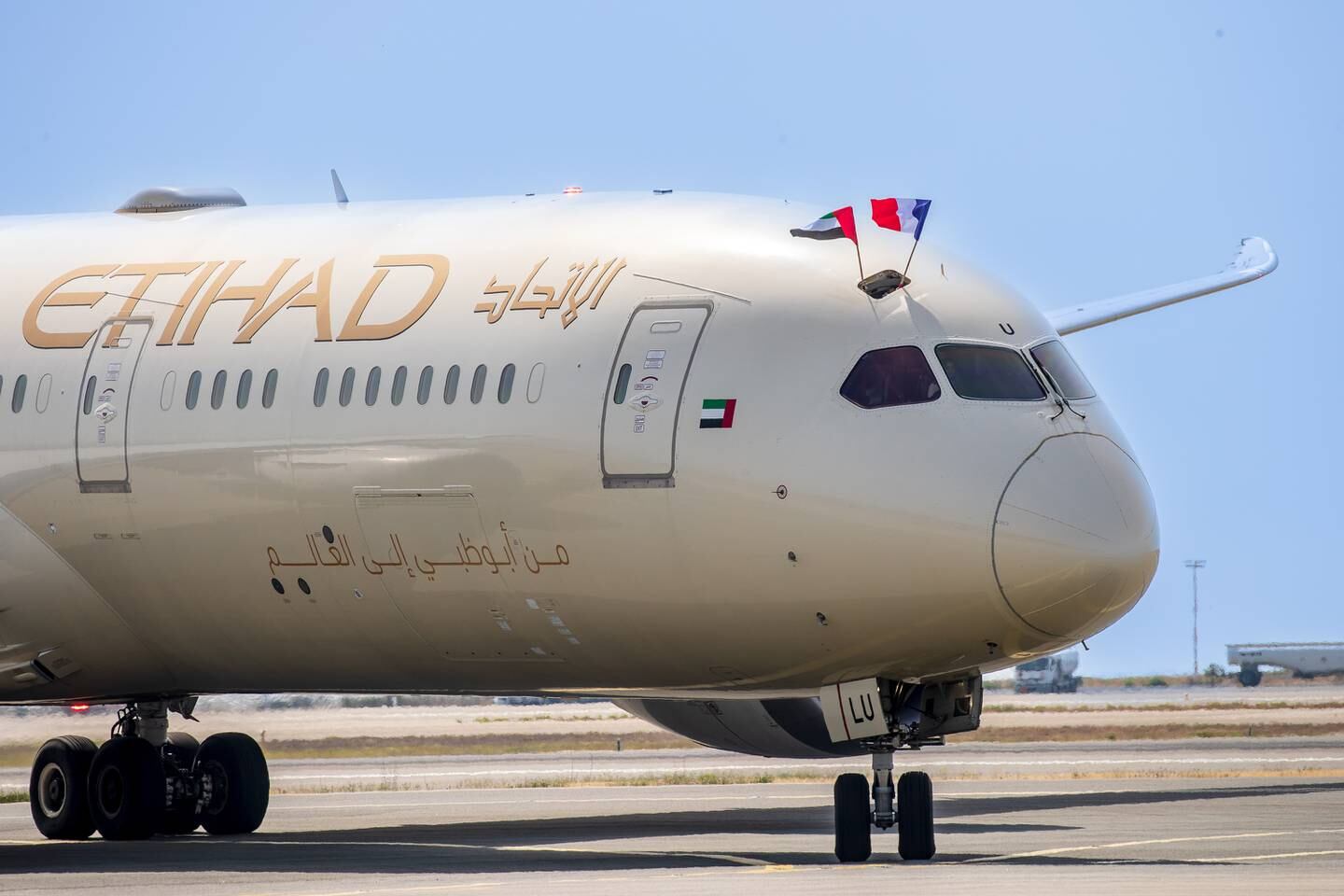 Pilots wave UAE and French flags from the cockpit of Etihad's first flight to Nice. Photo: Etihad