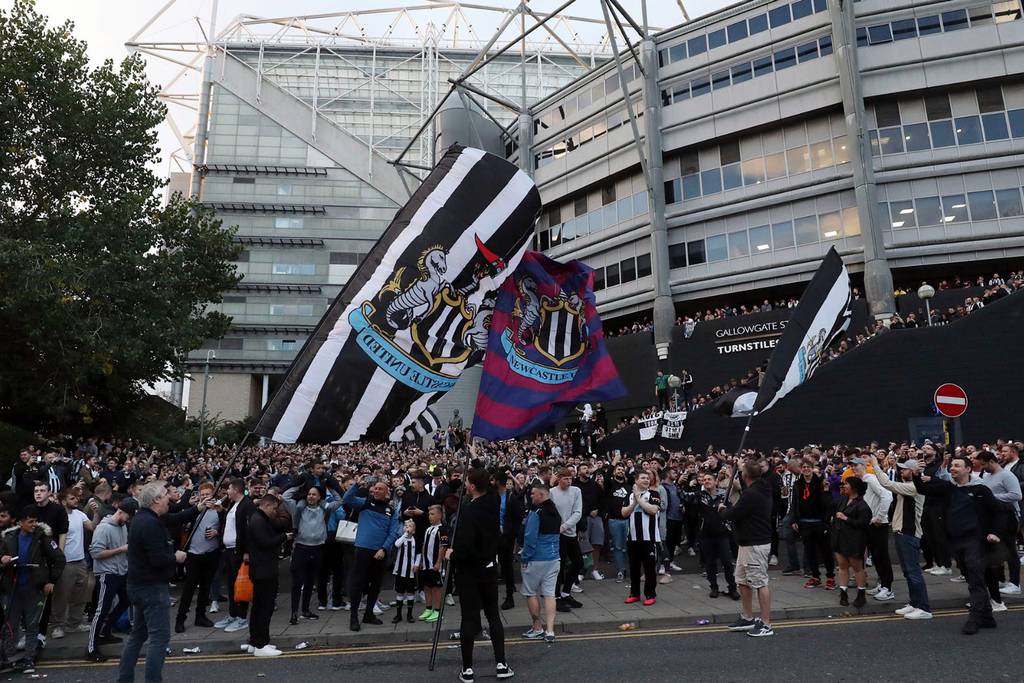 Newcastle United fans celebrate as Saudi-backed consortium takes over