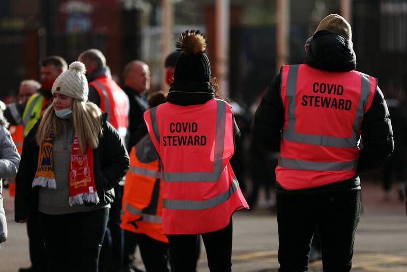 Fans show their coronavirus passes for checking outside Anfield stadium before the FA Cup tie between Liverpool and Shrewsbury Town, which the home side won 4-1. Reuters