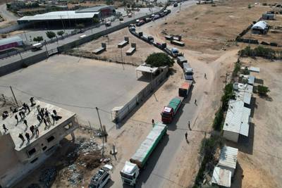 A convoy of lorries carrying humanitarian aid enter the Gaza Strip from Egypt via the Rafah border crossing on October 21, 2023. AFP