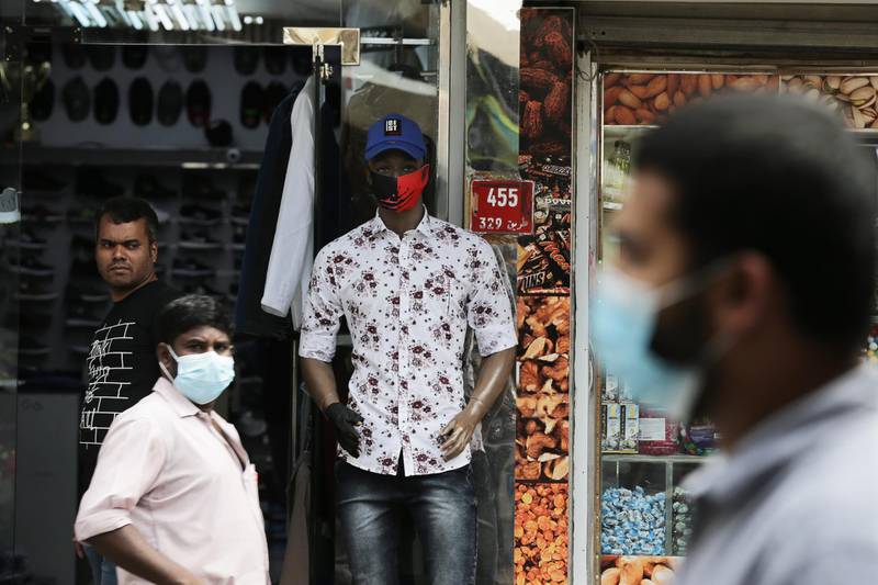 People wear protective face masks in a street of Manama, Bahrain. All types of education facilities, gyms, cinemas, and restaurants have been closed amid the coronavirus pandemic. EPA