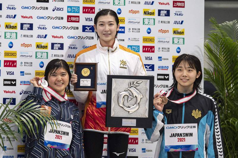 Japanese swimmers, gold medallist Rikako Ikee, centre, silver medallist Suzuka Hasegawa, left, and bronze medallist Chiharu Iitsuka after competing in the 100m butterfly final during the Japan National Swimming Championships. AFP