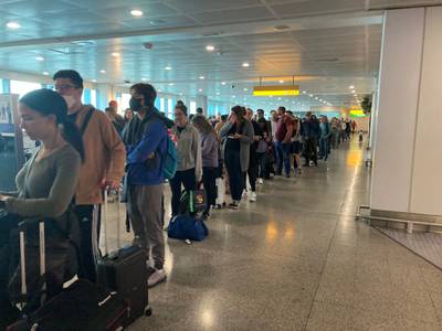 Long queues form through a terminal. PA