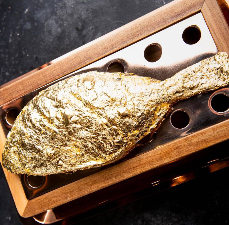Doors Freestyle Grill serves sea bass coated in 23K gold. Courtesy Doors Freestyle Grill