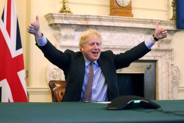 Boris Johnson throws his arms in the air as he declares 'A deal is done'
