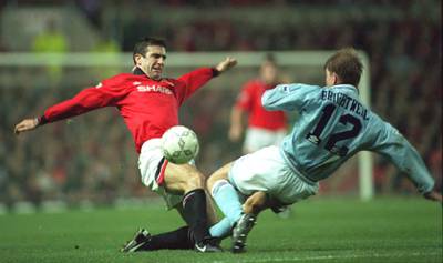 10 NOV 1994:  ERIC CANTONA OF MANCHESTER UNITED CHALLENGES  IAN BRIGHTWELL OF MANCHESTER CITY DURING THE ENGLISH PREMIER LEAGUE MATCH AT OLD TRAFFORD, MANCHESTER.  MANCHESTER UNITED WON 5-0. Mandatory Credit: Clive Brunskill/ALLSPORT