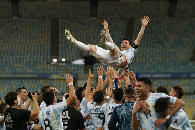 Players from Argentina toss Lionel Messi in the air as they celebrate their victory against Brazil in the Copa America final. EPA