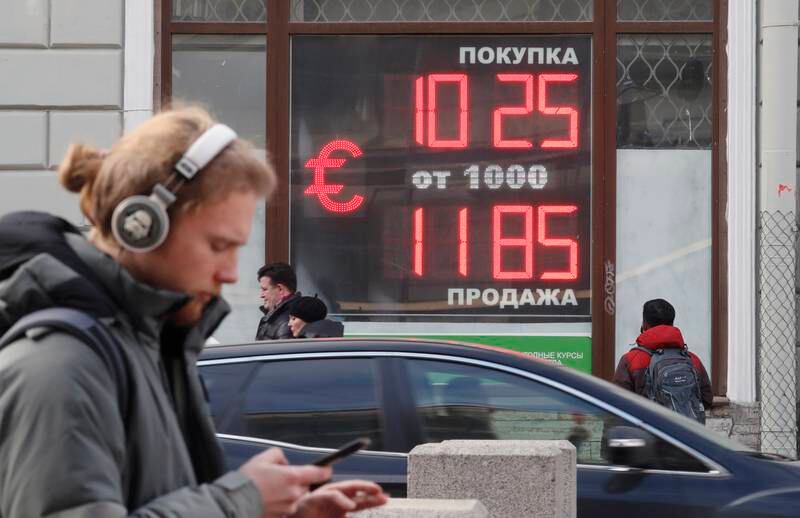 A digital panel displays the euro and US dollar currency rate at an exchange office in St Petersburg, Russia. EPA