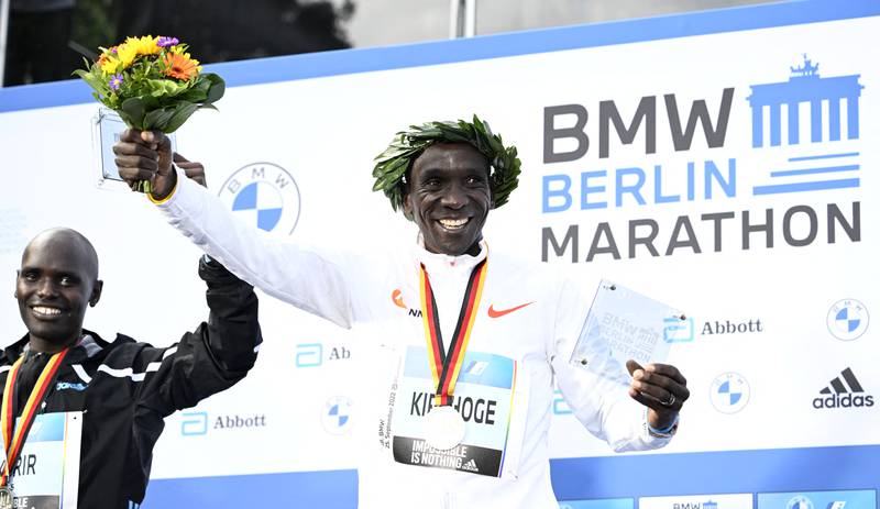 Second placed Mark Korir and winner Eliud Kipchoge celebrate on the podium after the Berlin Marathon. AFP