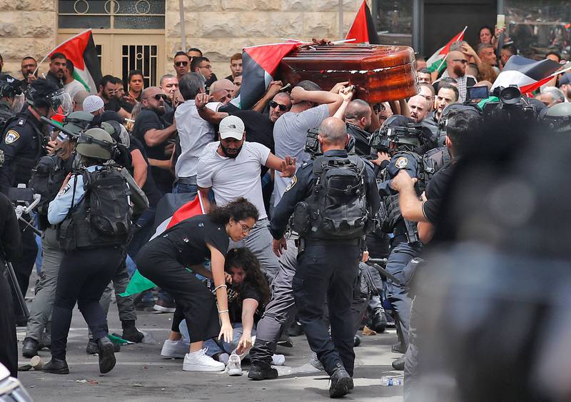 Violence erupts between Israeli security forces and mourners carrying the casket of killed Al Jazeera journalist Shireen Abu Akleh before it is taken to a church and then to her final resting place in Jerusalem. AFP