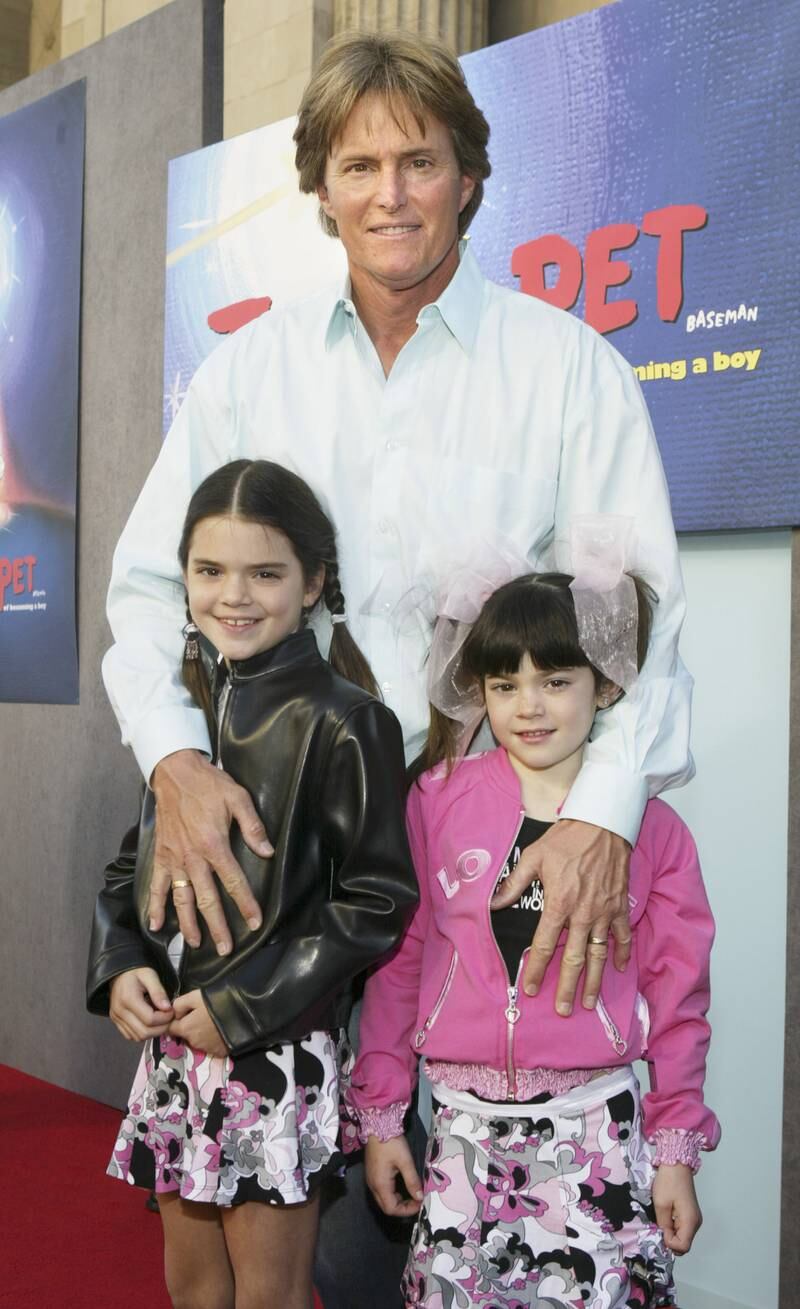 Bruce Jenner with daughters Kendall and Kylie, wearing a floral skirt and pink jacket, at the premiere of 'Teacher's Pet' on January 11, 2004 in Hollywood. Getty Images