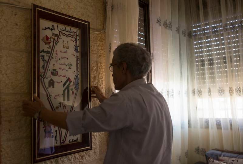 Mahmoud Al Mahdi ,73, hangs a framed map of Palestine that consists of tiny hand made embroidery stitches handmade by his wife on the wall of their home on a rocky hillside in Abu Dis, a Jerusalem suburb separated from the holy city by Israel��s concrete security barrier.
Mr Al Mahdi was at university in Iraq on the day that Israel destroyed the neighborhood where he grew up. It was June 10, 1967, three days after Israel had captured Jerusalem��s Old City from Jordan and the last day of what today is known as the Six-Day War.His wife was there and she took the outfit from her childhood, which she later lost.
(Photo by Heidi Levine for The National). *** Local Caption ***  Levine Moroccan Quarter Sty10.JPG