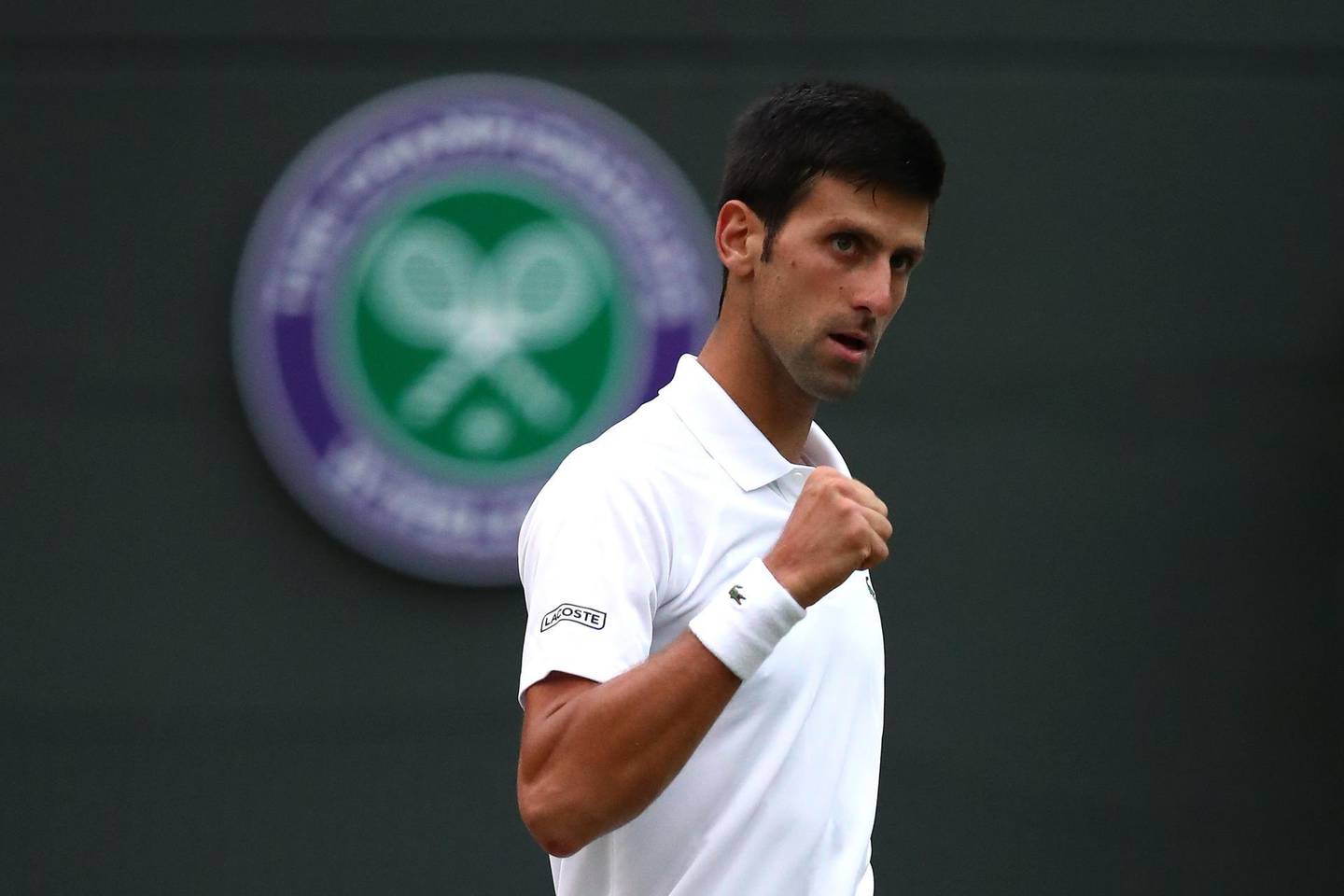 LONDON, ENGLAND - JULY 09:  Novak Djokovic of Serbia celebrates match point against Karen Khachanov of Russia during their Men's Singles fourth round match on day seven of the Wimbledon Lawn Tennis Championships at All England Lawn Tennis and Croquet Club on July 9, 2018 in London, England.  (Photo by Clive Brunskill/Getty Images)
