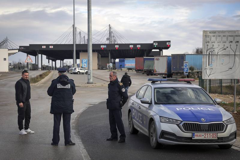 Kosovo police officers advise travellers at the closed Merdare border crossing between Kosovo and Serbia. AP