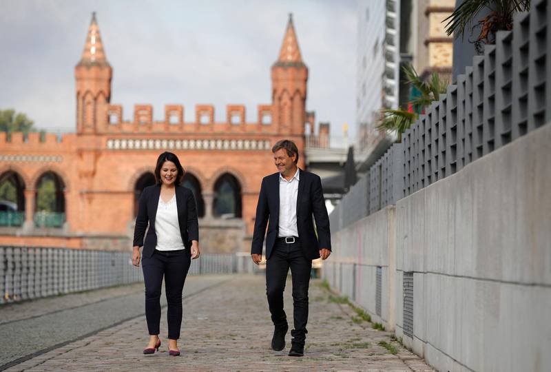 (FILES) This file photo taken on August 31, 2020 shows the co-leaders of Germany's Green party Annalena Baerbock (L) and Robert Habeck walking along the river Spree as they arrive for a closed meeting with the Greens' leadership in Berlin. Germany's Green party on Monday, April 19, 2021 named its co-chair Annalena Baerbock as their candidate to succeed Angela Merkel, throwing down the gauntlet to the chancellor's conservatives who were locked in increasingly vicious infighting for her crown. / AFP / Odd ANDERSEN
