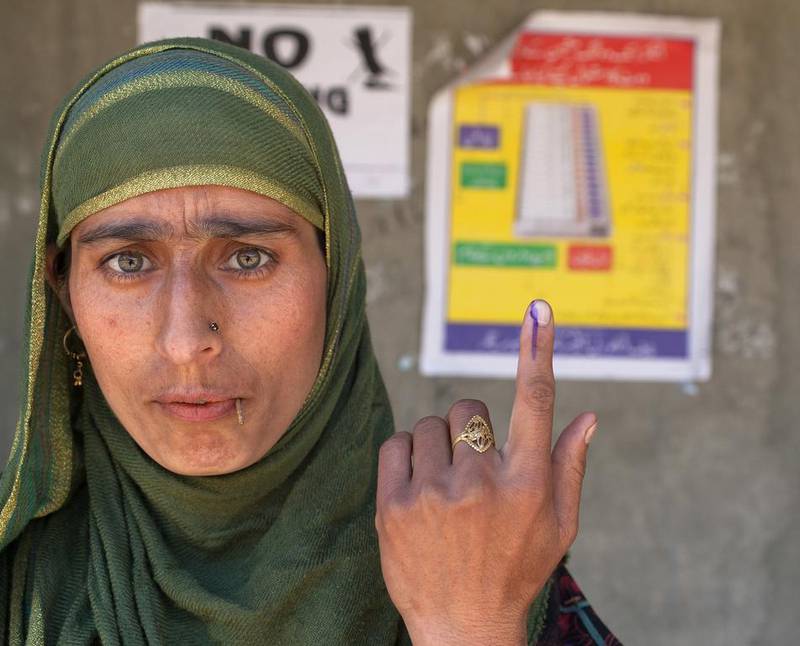 A Kashmiri Muslim woman show her indelible ink marked finger after casting her vote during the sixth phase of Indian parliamentary elections on in Vejbeour 45 km (28 miles) south of Srinagar. (Yawar Nazir / Getty Images / April 24, 2014)