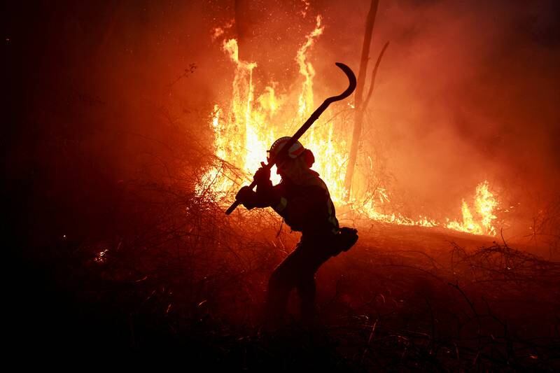 A Galician firefighter during an outbreak of wildfires in Piedrafita, Spain. Reuters