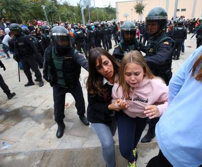Scuffles break out between a crowd and Spanish Civil Guard officers, outside a polling station for the banned independence referendum in Spain. Albert Gea / Reuters