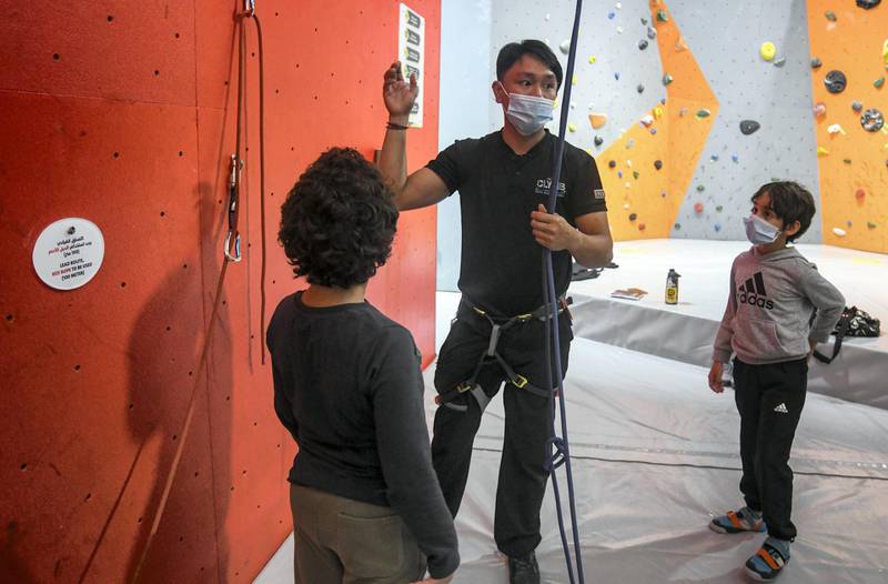 Abu Dhabi, United Arab Emirates - Mazen, 7, and Samih, 9, receive instructions before taking on indoor climbing at CLYMB, Yas Island. Khushnum Bhandari for The National