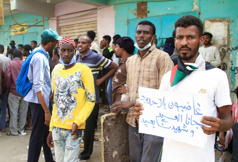 A Sudanese protester carries a placard which reads: 'Angry without borders, Eid is here and the martyr is absent' as he takes part in a rally in southern Khartoum. AFP