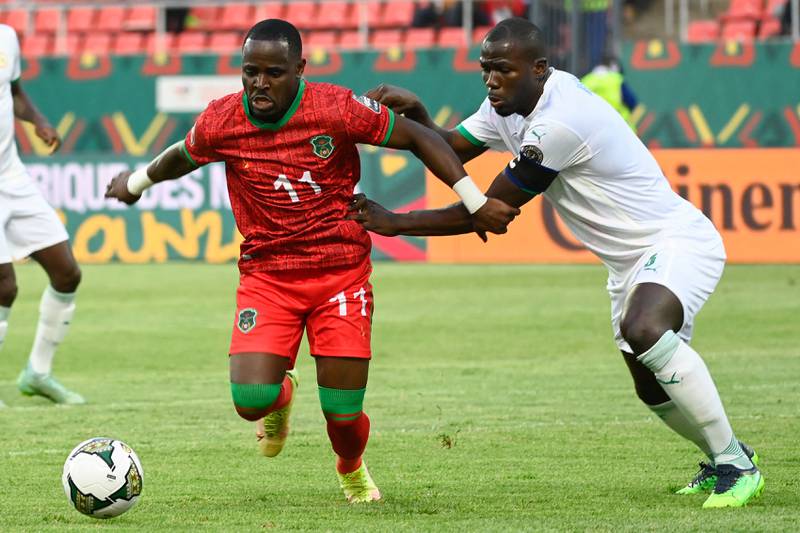 Malawi's Gabadinho Mhango, left, under pressure from Senegal defender Kalidou Koulibaly during the Africa Cup of Nations match in Bafoussam, on Tuesday, January 18, 2022. AFP