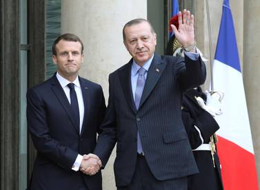In this file photo taken on January 5, 2018 French President Emmanuel Macron (L) greets his Turkish counterpart Recep Tayyip Erdogan upon his arrival at the Elysee palace in Paris. AFP