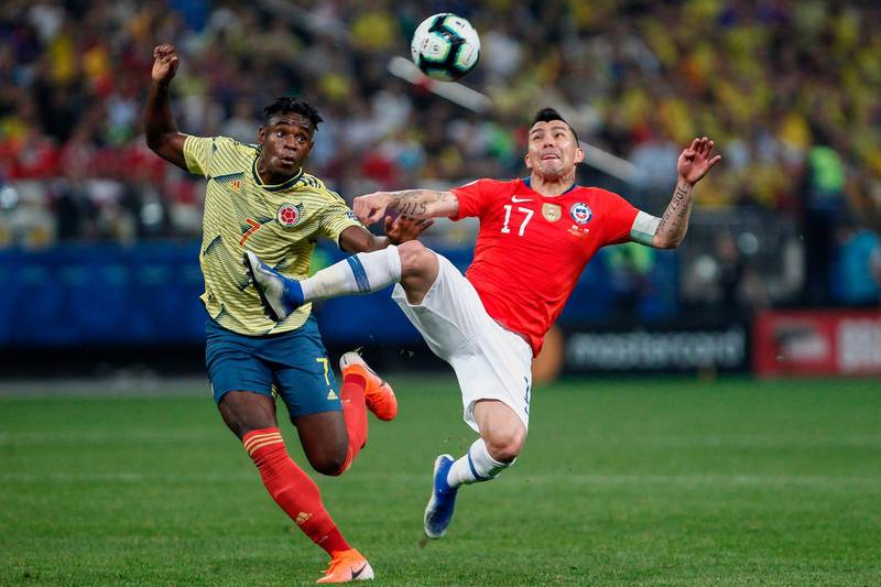 Colombia's Duvan Zapata (L) and Chile's Gary Medel vie for the ball. AFP