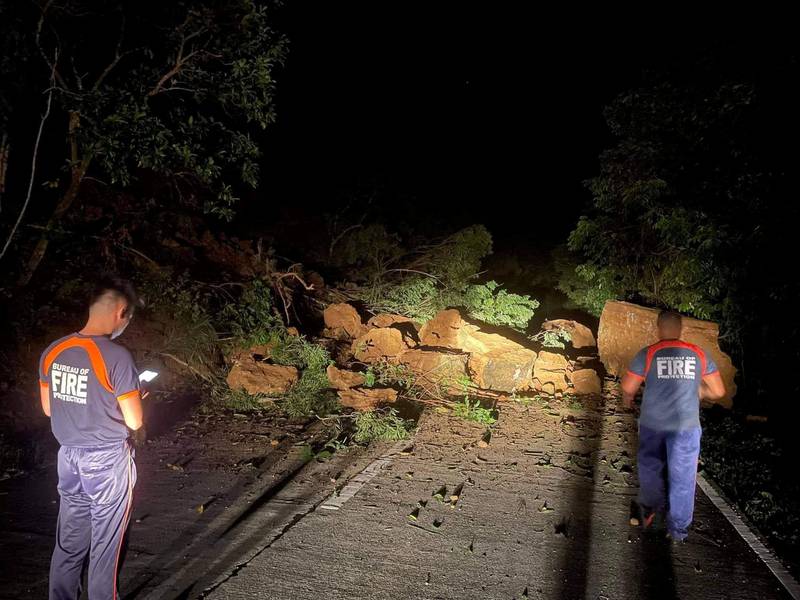 Bureau of Fire Protection members on a road blocked by debris after an earthquake in Ilocos Norte Province, Philippines, October 25, 2022. Reuters