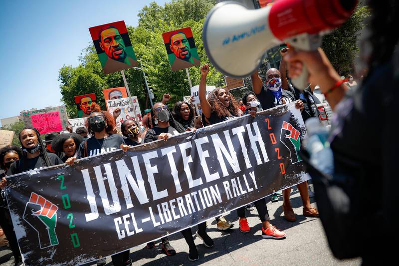 FILE- In this June 19, 2020, file photo, protesters chant as they march after a Juneteenth rally at the Brooklyn Museum, in the Brooklyn borough of New York. (AP Photo/John Minchillo, File)
