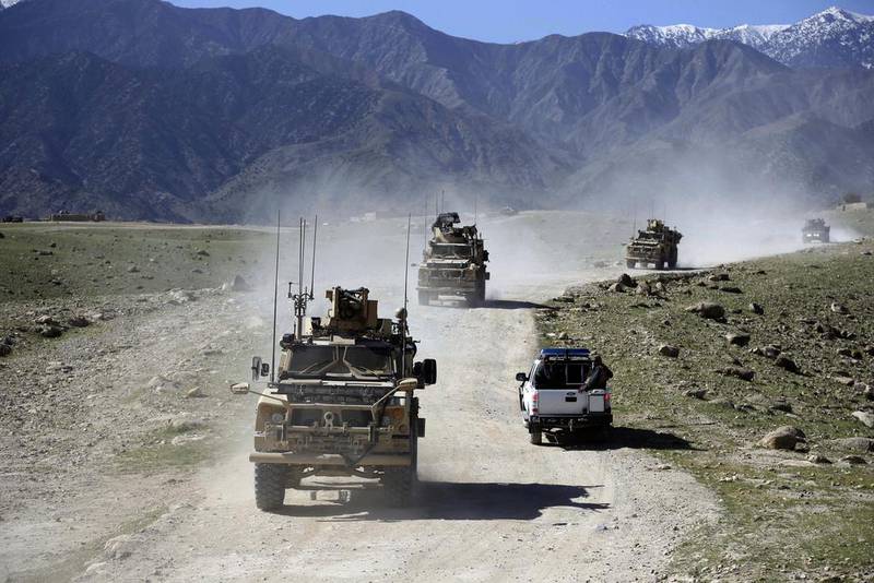 US forces and Afghan commandos patrol Pandola village near the site of a US bombing in the Achin district of Jalalabad, east of Kabul. Rahmat Gul / AP Photo