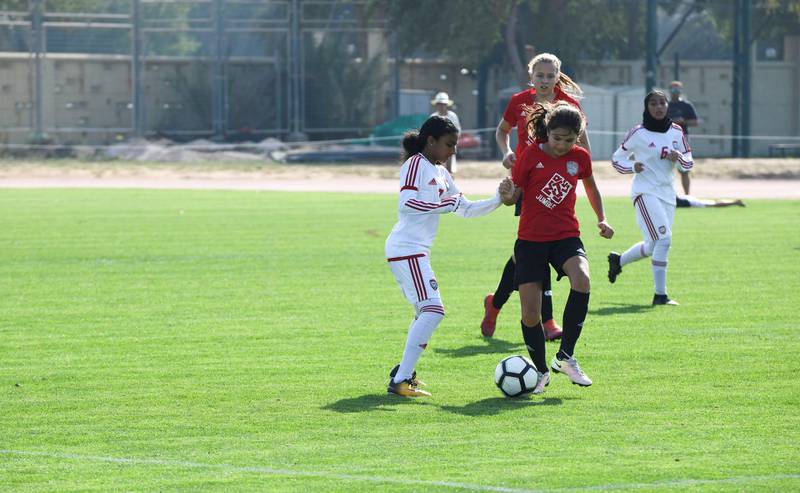 Abu Dhabi, United Arab Emirates - Girls also took part for the first time, Go Pro (red) from Dubai vs. UAE National team (white) under 14 age group on Abu Dhabi World Cup Day 1 at Zayed Sports City. Khushnum Bhandari for The National
