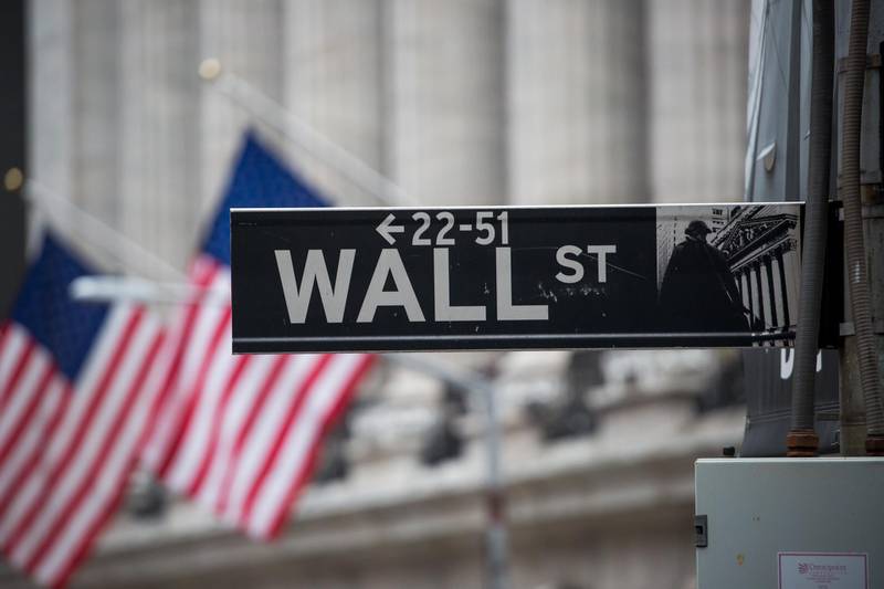 A Wall Street sign is displayed in front of New York Stock Exchange (NYSE) in New York, U.S., on Wednesday, Feb. 26, 2020. U.S. equities swung between gains and losses as investors digested fresh evidence of the widening coronavirus outbreak. Photographer: Michael Nagle/Bloomberg