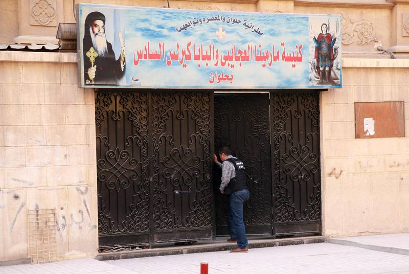 An Egyptian security member inspect the entrance gate of the church. Samer Abdallah / AFP Photo