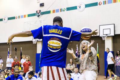 Handles from the Harlem Globetrotters shows off his basketball skills in front of more than 500 pupils at Dubai International Academy.  Reem Mohammed / The National