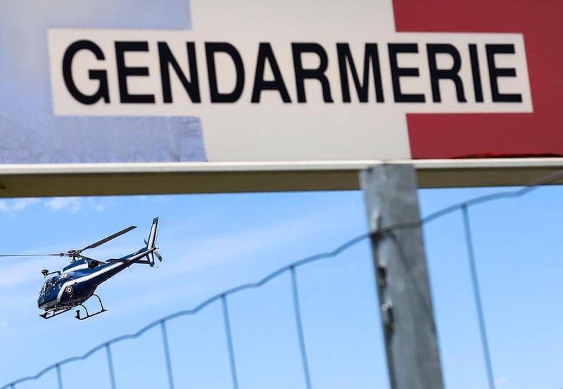 A helicopter of the French gendarmerie flies over the A89 highway during the manhunt in France's Dordogne region.
 AFP