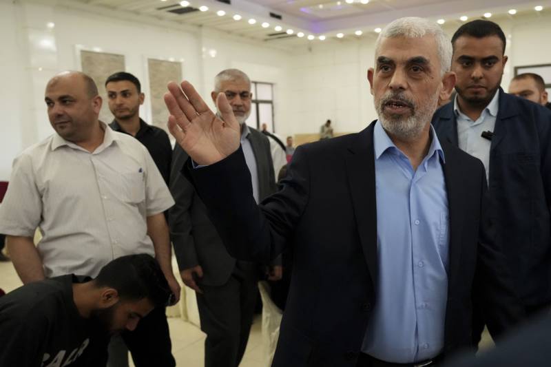 Yahya Sinwar, head of Hamas in Gaza, greets his supporters upon his arrival at a public meeting in Gaza City. AP