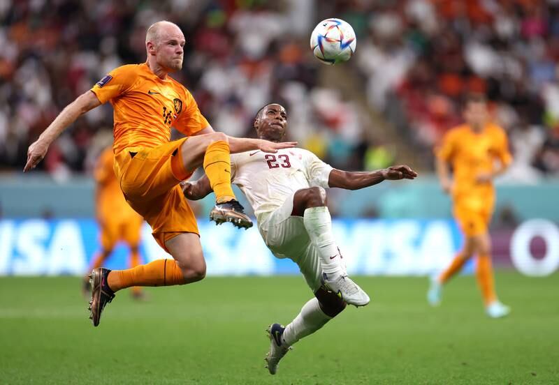 Dutch midfielder Davy Klaassen battles for the ball with Assim Madibo of Qatar. Getty