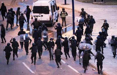 Moroccan riot police retreat as they are pelted with stones during the unrest. AFP