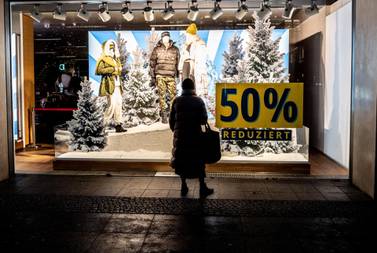 A pedestrian outside a closed shop in Berlin, Germany. The November decline in eurozone retail sales was the most since April when the first wave of lockdowns was fully under way. EPA