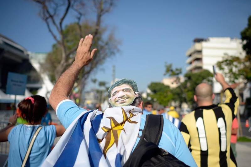 A fan wearing a Luis Suarez mask walks outside prior to the match between Uruguay and Colombia at the 2014 World Cup in Saturday. Alexandre Loureiro / Getty Images