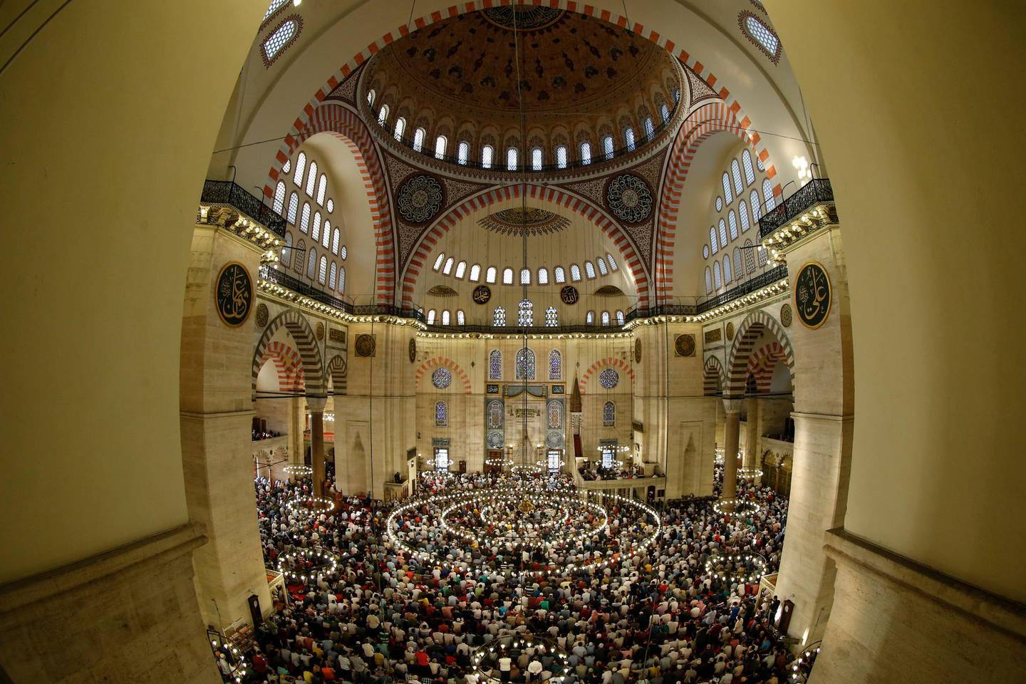 Turkey's Muslims offer prayers during the first day of Eid al-Fitr, which marks the end of the holy fasting month of Ramadan at the the Suleymaniye Mosque in Istanbul, early Friday, June 15, 2018. (AP Photo/Emrah Gurel)