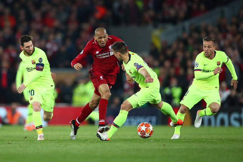 LIVERPOOL, ENGLAND - MAY 07:  Fabinho of Liverpool is stopped Lionel Messi and Clement Lenglet of Barcelona during the UEFA Champions League Semi Final second leg match between Liverpool and Barcelona at Anfield on May 07, 2019 in Liverpool, England. (Photo by Clive Brunskill/Getty Images)