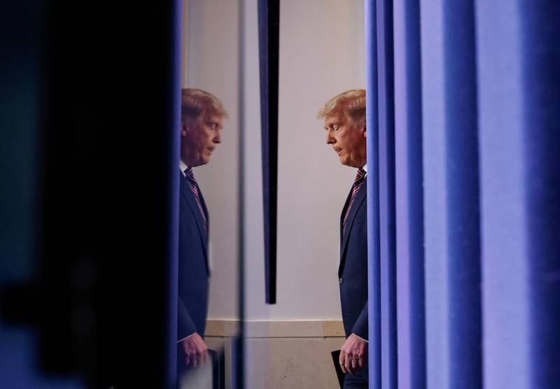 U.S. President Donald Trump is reflected as he arrives to speak at the White House in Washington. Reuters