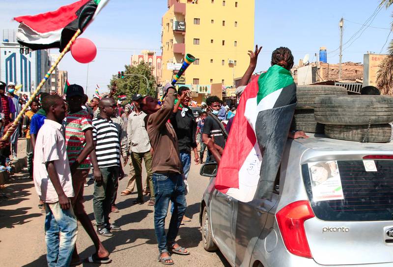 Sudanese demonstrators march in Khartoum. Roads leading to military headquarters and the presidential palace were reported to have been sealed off by government forces. AFP