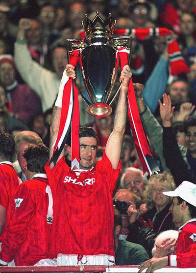 MANCHESTER, UNITED KINGDOM - MAY 03: Manchester United player Eric Cantona lifts the FA Premier League trophy as United celebrate being the first winners of the FA Premier League for the season 1992/93 after the game against Blackburn Rovers at Old Trafford on May 3, 1993 in Manchester, England.  (Photo by Shaun Botterill/Getty Images)