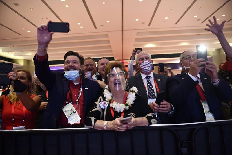 Delegates cheer as US President Donald Trump speaks during the first day of the Republican National Convention on August 24, 2020, in Charlotte, North Carolina.  President Donald Trump went into battle for a second term Monday with his nomination at a Republican convention where he will draw on all his showman's instincts to try and change the narrative in an election he is currently set to lose. / AFP / Brendan Smialowski
