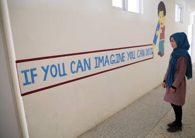 Fatima reads a motivational message at the school as she arrives for a counselling session. Reuters