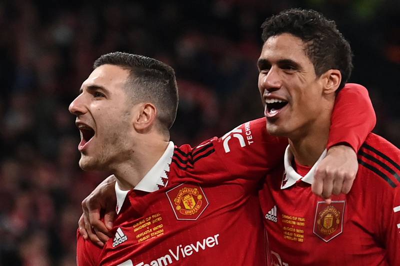 Manchester United's Diogo Dalot and Raphael Varane celebrate at the final whistle. AFP