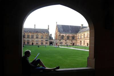 A student reads while sitting on a ledge at the Quadrangle of the University of Sydney, Australia May 2, 2017. International students are expected to begin returning to Australia next month despite Chinese warnings of pandemic-related racism, the Australian prime minister said on Friday, June 12, 2020. (Paul Miller/AAP Image via AP)