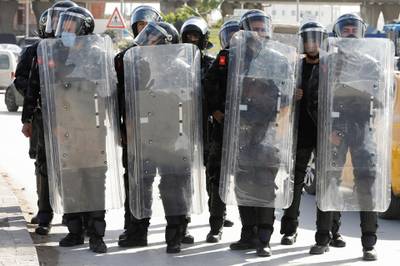 Members of the police stand guard during an anti-government protest in Tunis. Reuters